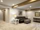 Relaxing lower-level living room with cozy seating, carpet, and wood beam accents at , Noblesville, IN 46060