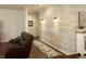 Cozy living room showcasing a whitewashed shiplap accent wall, hardwood floors, and sconce lighting at , Noblesville, IN 46060