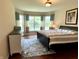 Bright main bedroom with large windows, hardwood floors, and a comfortable bed with a patterned rug at , Noblesville, IN 46060
