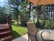 Relaxing patio area with outdoor seating, lush green lawn, and mature trees offering shade and privacy at 11700 Harvest Moon Dr, Noblesville, IN 46060