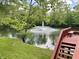 Scenic pond view with a fountain and a wooden deck with bench seating at , Noblesville, IN 46060