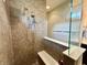 Stylish tiled shower featuring a bench, dual showerheads, and glass enclosure at , Noblesville, IN 46060