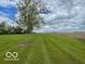 A well-manicured lawn with tall grasses extending out into the horizon under cloudy skies at 11898 N 200 W, Fountaintown, IN 46130