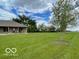 Expansive backyard with lush green lawn, mature trees, and a view of the home at 11898 N 200 W, Fountaintown, IN 46130