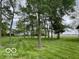 View of the backyard with lush green grass and trees at 11898 N 200 W, Fountaintown, IN 46130