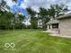 Spacious backyard featuring a well-maintained lawn and mature trees, perfect for outdoor activities at 11898 N 200 W, Fountaintown, IN 46130