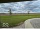 Expansive backyard featuring lush green lawn and picturesque field views, perfect for outdoor enjoyment at 11898 N 200 W, Fountaintown, IN 46130