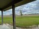 Scenic backyard view from the covered patio, showcasing a lush lawn and expansive field at 11898 N 200 W, Fountaintown, IN 46130