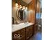 Well-lit bathroom featuring wooden cabinets, white countertop, and an oval mirror at 11898 N 200 W, Fountaintown, IN 46130