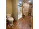 Well-designed bathroom with a toilet, shower, and wood walls at 11898 N 200 W, Fountaintown, IN 46130