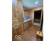 Well-lit bathroom featuring wood walls, cabinets, and tile floors at 11898 N 200 W, Fountaintown, IN 46130
