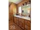 Bathroom featuring wood walls, cabinets, white countertop, and sink at 11898 N 200 W, Fountaintown, IN 46130