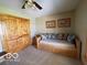 Bedroom showcasing a daybed with decorative pillows and natural wooden closet doors at 11898 N 200 W, Fountaintown, IN 46130