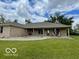 Exterior view of a brick home with a covered porch and manicured lawn at 11898 N 200 W, Fountaintown, IN 46130