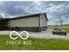Outdoor view of the property with garden beds, gravel, and lush grass at 11898 N 200 W, Fountaintown, IN 46130