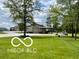 View of garage with adjacent green space, showcasing the property's setting at 11898 N 200 W, Fountaintown, IN 46130