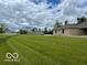 A huge backyard with neatly cut grass that leads to a brick home at 11898 N 200 W, Fountaintown, IN 46130