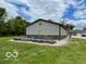 Exterior view of barn-style home with raised garden beds and green lawn at 11898 N 200 W, Fountaintown, IN 46130
