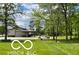 Property view showing a large garage, green space, and well-maintained grounds at 11898 N 200 W, Fountaintown, IN 46130