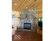 Stone fireplace with wooden mantle and a cozy ambiance at 11898 N 200 W, Fountaintown, IN 46130