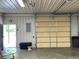 View of garage interior with door access to exterior and garage door at 11898 N 200 W, Fountaintown, IN 46130