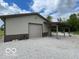 Garage exterior with concrete gravel, metal siding and two-tone paint at 11898 N 200 W, Fountaintown, IN 46130