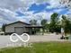 Large garage with a convenient covered parking area and ample gravel space at 11898 N 200 W, Fountaintown, IN 46130