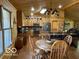 Kitchen with custom cabinets, an island with seating, and a dining area at 11898 N 200 W, Fountaintown, IN 46130