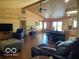 Open-concept living area with dining space, featuring wooden walls and hardwood floors at 11898 N 200 W, Fountaintown, IN 46130