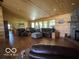 Spacious living room with hardwood floors, wood paneled walls, and large windows for natural light at 11898 N 200 W, Fountaintown, IN 46130