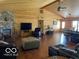 Open-concept living area with dining space, featuring wooden walls and hardwood floors at 11898 N 200 W, Fountaintown, IN 46130