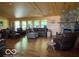 Inviting living room with wood paneling, fireplace, and comfortable seating at 11898 N 200 W, Fountaintown, IN 46130