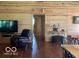 Comfortable living room features wood-paneled walls, a TV, leather chair, and rustic decor at 11898 N 200 W, Fountaintown, IN 46130