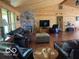 Spacious living room with wood floors, a fireplace, and plenty of natural light at 11898 N 200 W, Fountaintown, IN 46130