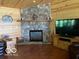 Living room featuring a stone fireplace and wooden accents at 11898 N 200 W, Fountaintown, IN 46130