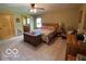 Bright primary bedroom with a wooden bed frame and a view of the outdoors at 11898 N 200 W, Fountaintown, IN 46130