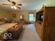 Bright primary bedroom with a ceiling fan, large closet, and a view of the outdoors at 11898 N 200 W, Fountaintown, IN 46130