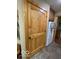 Charming, rustic pantry door with knotty-pine detailing and matching trim at 11898 N 200 W, Fountaintown, IN 46130
