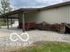Patio area with seating, a wood pile, and gravel space at 11898 N 200 W, Fountaintown, IN 46130