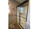 Bathroom shower with textured glass doors and a window providing natural light at 11898 N 200 W, Fountaintown, IN 46130