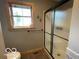 Bathroom shower with textured glass doors and a window providing natural light at 11898 N 200 W, Fountaintown, IN 46130