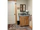 Small utility sink featuring wood cabinetry, a mirror, and a towel rack at 11898 N 200 W, Fountaintown, IN 46130