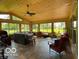 Bright sunroom featuring a vaulted wood ceiling, slate floors, and comfortable seating at 11898 N 200 W, Fountaintown, IN 46130