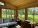 Relaxing sunroom featuring a comfortable sofa and views of the well-maintained yard at 11898 N 200 W, Fountaintown, IN 46130