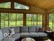 Cozy sunroom with comfortable sectional sofa and picturesque views of the outdoors at 11898 N 200 W, Fountaintown, IN 46130