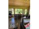 Well-lit sunroom featuring a wooden bar, plants, and access to the backyard at 11898 N 200 W, Fountaintown, IN 46130