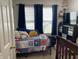 Cozy bedroom with natural light, featuring sporty quilt, decor, and storage for an organized space at 1420 Wigwam Ln, Martinsville, IN 46151