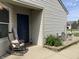 Inviting front porch with rocking chair and blue door, complete with decorative garden and landscaping at 1420 Wigwam Ln, Martinsville, IN 46151