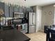 Well-lit kitchen featuring modern appliances, gray cabinets, and updated countertops for a stylish cooking experience at 1420 Wigwam Ln, Martinsville, IN 46151