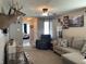 Cozy living room with neutral tones, comfortable seating and decor throughout at 1420 Wigwam Ln, Martinsville, IN 46151